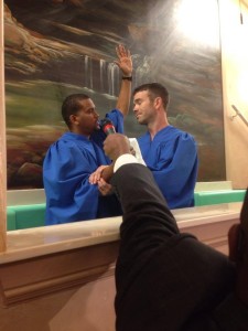 young man getting baptized